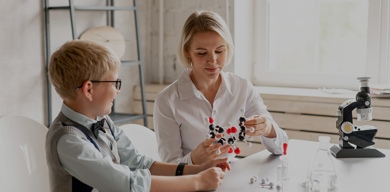 Female science tutor in New Rochelle studying chemistry with student